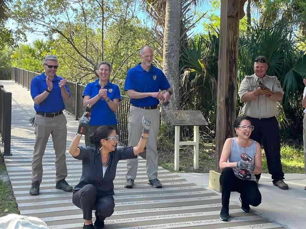 U.S. Secretary of the Interior Deb Haaland and Assistant Secretary of the Interior Shannon Estenoz are joined by other Department of the Interior staff on Monday to add a plank commemorating the designation of the Everglades to Gulf Conservation Area at the boardwalk of Pelican Island National Wildlife Refuge in Vero Beach, Florida.