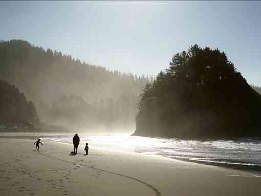 Oregon coast with family walking along beach